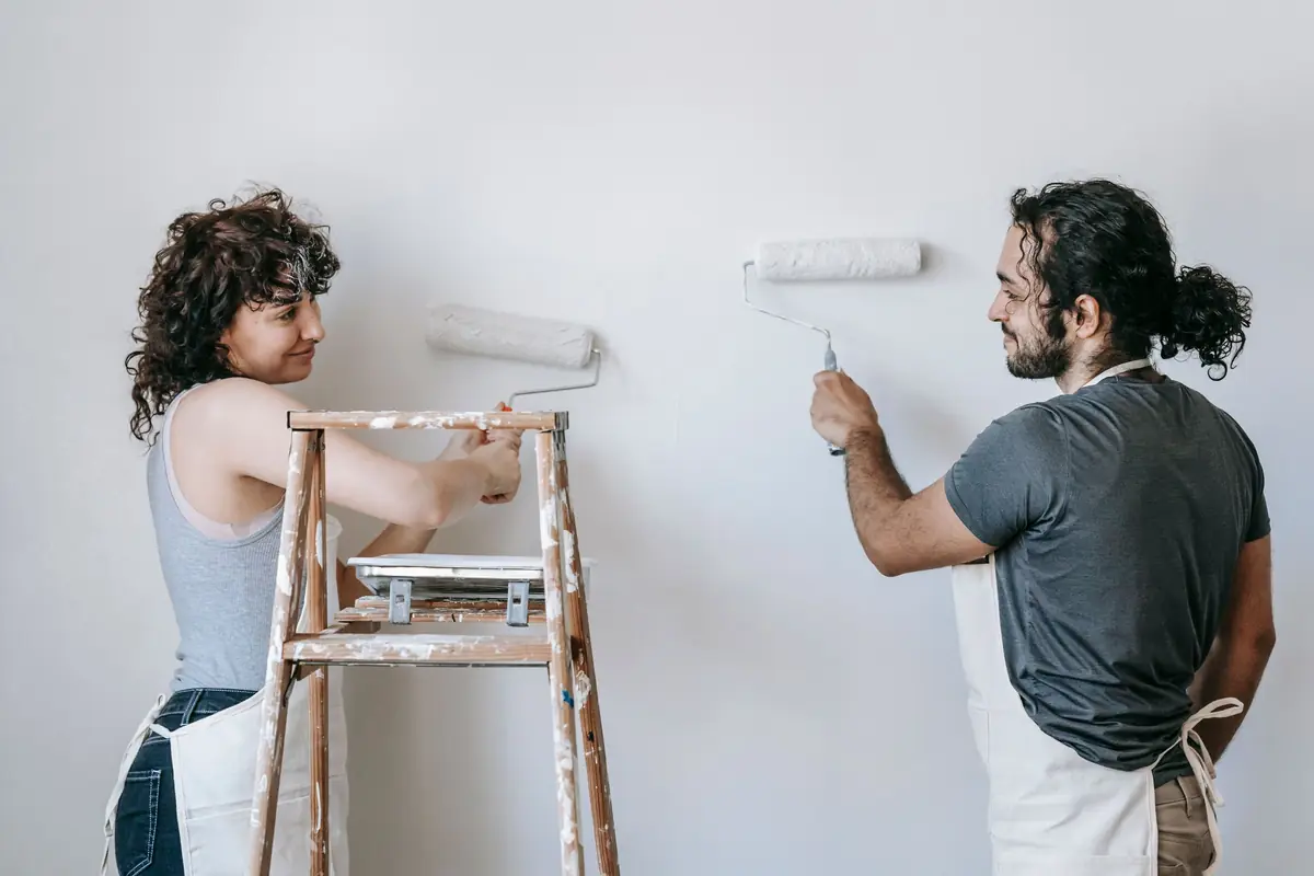 People painting a wall together — painting help in Madison
